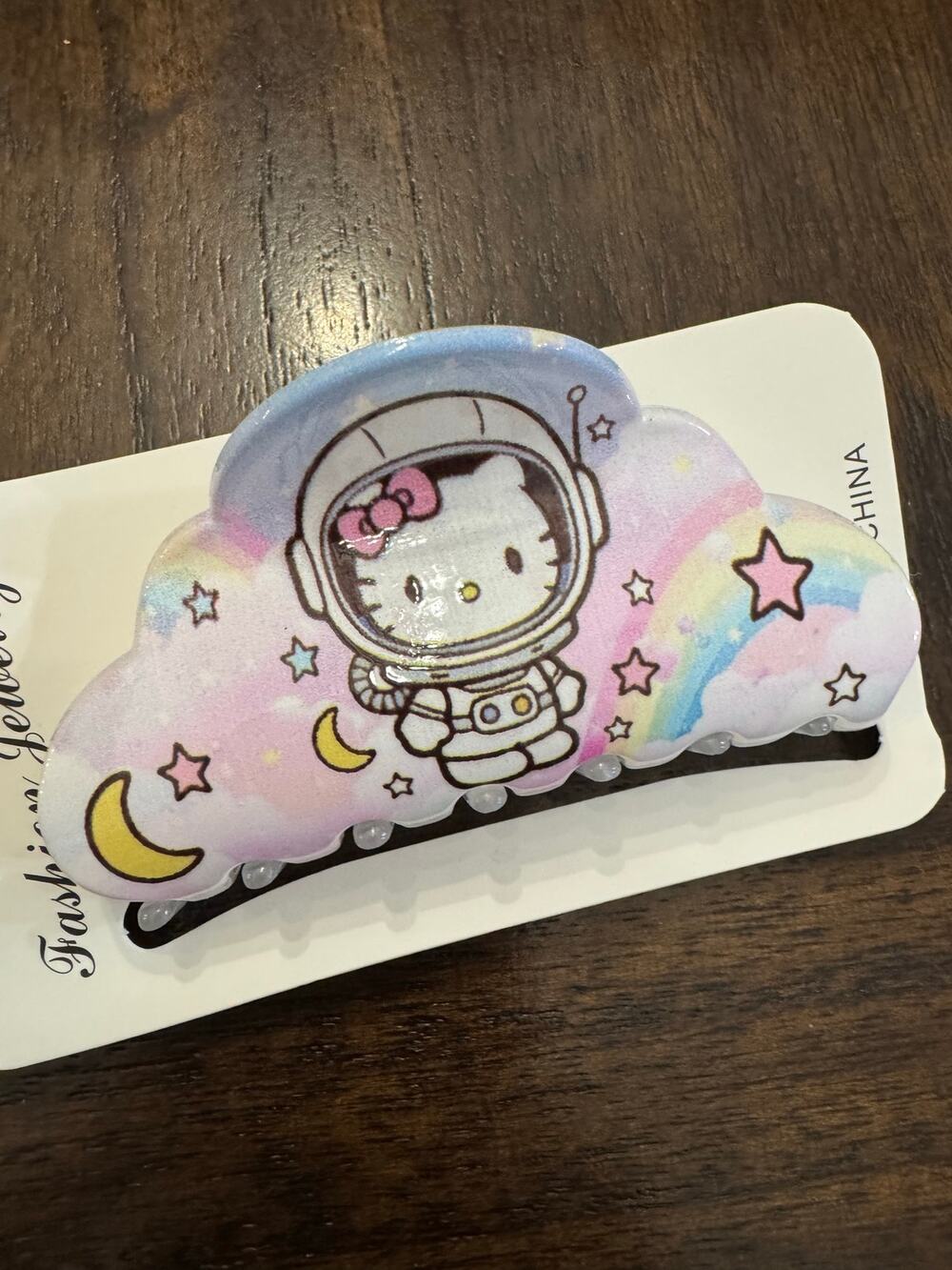 Hello Kitty astronaut hair clip claw with rainbow, stars, and moon design